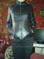 Короткая черная кожаная куртка с воротником стоичкой